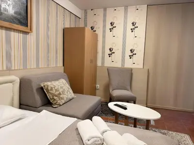 a room with a bed and a table and a chair at Vila club 011 in Dedinje