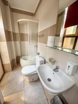 a bathroom with a sink and a toilet and a mirror at Vila club 011 in Dedinje