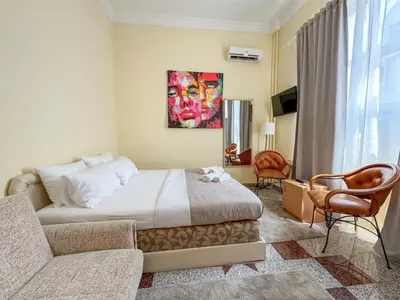 a hotel room with a bed and a couch at Vila club 011 in Dedinje