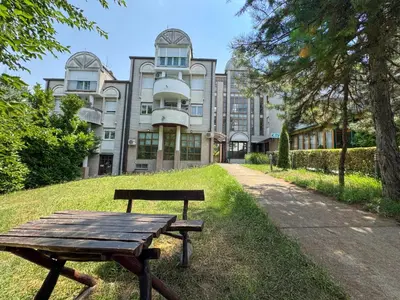 a wooden bench sitting in front of a building at Vila club 011 in Dedinje