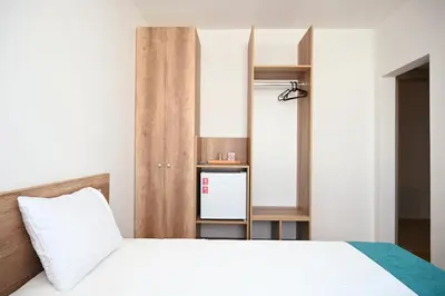a bedroom with a white bed and a mirror at Dona, Altina in Belgrade