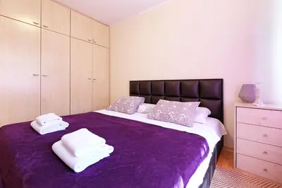 a bedroom with a purple bed with towels on it at Paradise Starry Suite-City center Belgrade in Belgrade