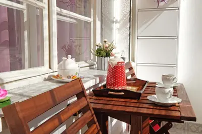 a dining room table with a tea pot and a table with a chair at Paradise Starry Suite-City center Belgrade in Belgrade