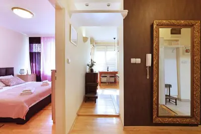 a bedroom with a bed and a mirror at Paradise Starry Suite-City center Belgrade in Belgrade