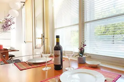a bottle of wine sitting on a table with two glasses at Paradise Starry Suite-City center Belgrade in Belgrade