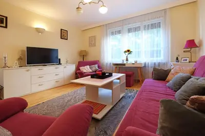 a living room with a couch and a tv at Paradise Starry Suite-City center Belgrade in Belgrade