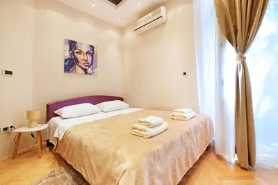 a bedroom with a bed with towels on it at Studio Paradise Forest in Belgrade