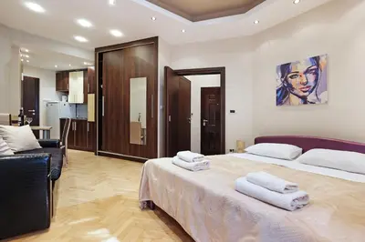 a bedroom with a large bed with towels on it at Studio Paradise Forest in Belgrade