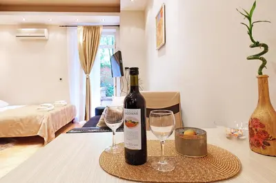 a bottle of wine and two glasses on a table at Studio Paradise Forest in Belgrade