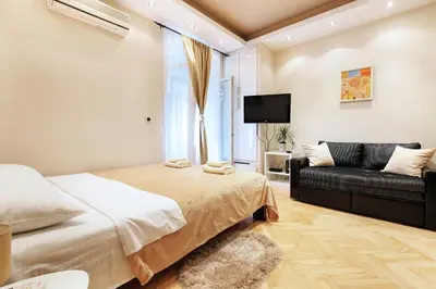 a bedroom with a bed and a couch at Studio Paradise Forest in Belgrade