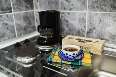 a cup of coffee sitting on top of a stove at City Center Studio in Belgrade
