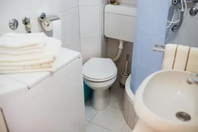 a bathroom with a white toilet and a sink at City Center Studio in Belgrade
