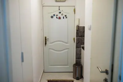 a white door with stickers on it in a bathroom at City Center Studio in Belgrade