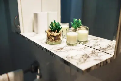 a counter with candles and potted plants on it at City Center Studio in Belgrade