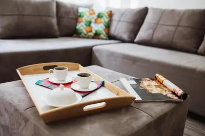 a tray with two cups and plates on a coffee table at City Center Studio in Belgrade
