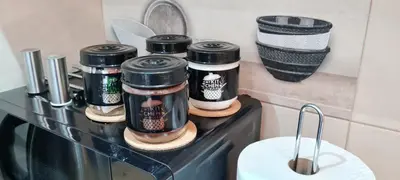 a counter with four coffee bottles on it at OLIVERA APARTMENT in Belgrade
