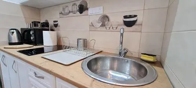 a kitchen counter with a sink in a kitchen at OLIVERA APARTMENT in Belgrade