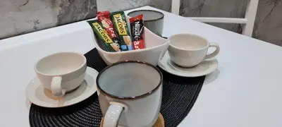 a table with a mirror and two cups and snacks at OLIVERA APARTMENT in Belgrade