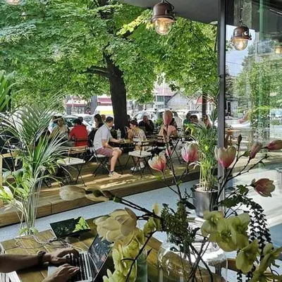 a group of people sitting at tables in a restaurant at OLIVERA APARTMENT in Belgrade