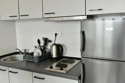 a kitchen with a stainless steel refrigerator and a sink at Apartment Vanilla Belgrade in Belgrade