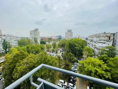 a city with cars parked in a parking lot at Apartment Vanilla Belgrade in Belgrade