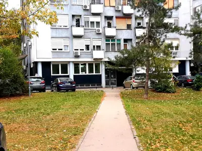 a building with cars parked in front of it at Apartment Vanilla Belgrade in Belgrade