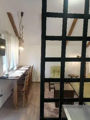 a dining room with a table and a table and chairs at Apartman Garden House in Voždovac