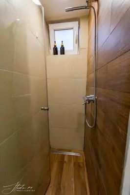 a bathroom with a shower with a glass door at Little L Apartments Dorcol in Belgrade
