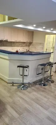 a kitchen with a counter and two stools at Le coin de Simon in Belgrade
