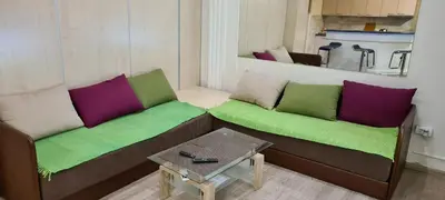 a living room with two couches and a table at Le coin de Simon in Belgrade