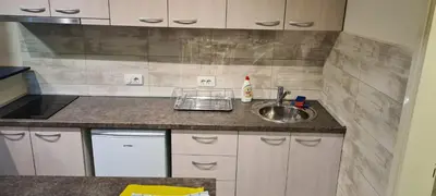 a small kitchen with a sink and a counter at Le coin de Simon in Belgrade
