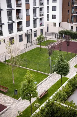 a park with benches and trees in front of a building at Zemun Luxury - Comfortable, workspace, quiet, free parking, Netflix in Belgrade