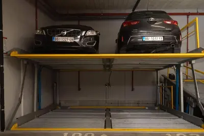 two cars sitting on a yellow shelf in a garage at Zemun Luxury - Comfortable, workspace, quiet, free parking, Netflix in Belgrade