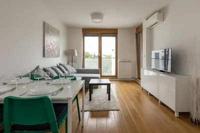 a living room with a table and a couch at Zemun Luxury - Comfortable, workspace, quiet, free parking, Netflix in Belgrade