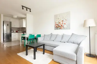 a living room with a white couch and a table at Zemun Luxury - Comfortable, workspace, quiet, free parking, Netflix in Belgrade