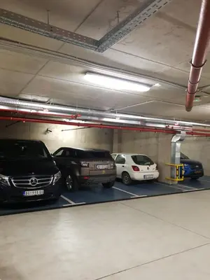 a parking garage with several cars parked in it at Central Park Residence in Belgrade