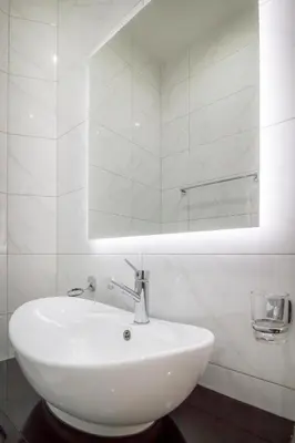 a white sink in a bathroom with a mirror at Central Park Residence in Belgrade