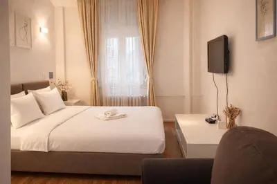 a bedroom with a bed and a tv on the wall at City Break Apartments Chic and Luxury in Belgrade