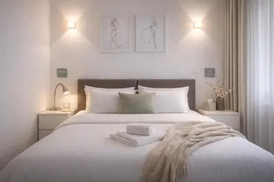a bedroom with a large white bed with towels on it at City Break Apartments Chic and Luxury in Belgrade