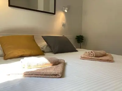 a bed with towels and pillows on it at City Break Apartments Chic and Luxury in Belgrade