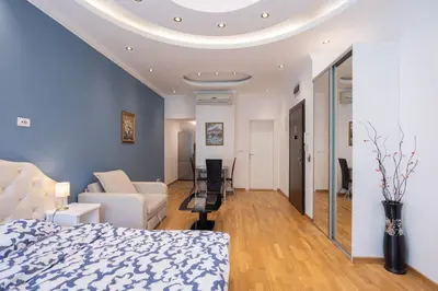 a bedroom with a bed and a living room at Belgrade Center Apartment Lux III in Belgrade