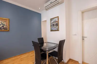 a dining room with a glass table and chairs at Belgrade Center Apartment Lux III in Belgrade