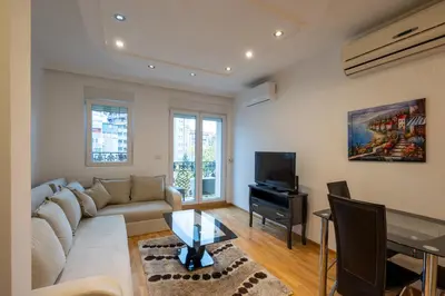 a living room with a couch and a tv at Belgrade Center Apartment Lux III in Belgrade