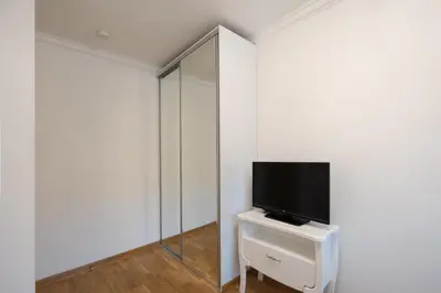 a living room with a tv and a mirror at Belgrade Center Apartment Lux III in Belgrade