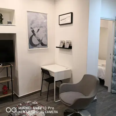 a room with a desk and a chair and a television at Bibi's apartment in Belgrade