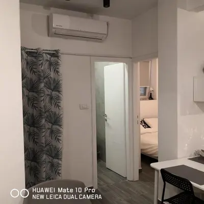 a hallway with a door to a room with a bedroom at Bibi's apartment in Belgrade