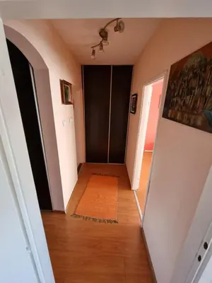 a hallway in a house with a hallway leading into a room at Large, Spacious Apartment Voždovac in Belgrade