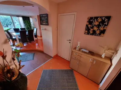 a living room with a table and chairs at Large, Spacious Apartment Voždovac in Belgrade