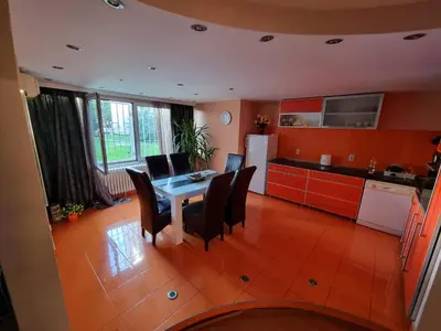 a kitchen with a table and chairs in a room at Large, Spacious Apartment Voždovac in Belgrade