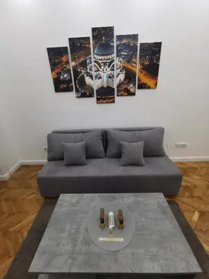 a living room with a couch and a table at Victory apartment - Heart of Belgrade in Belgrade